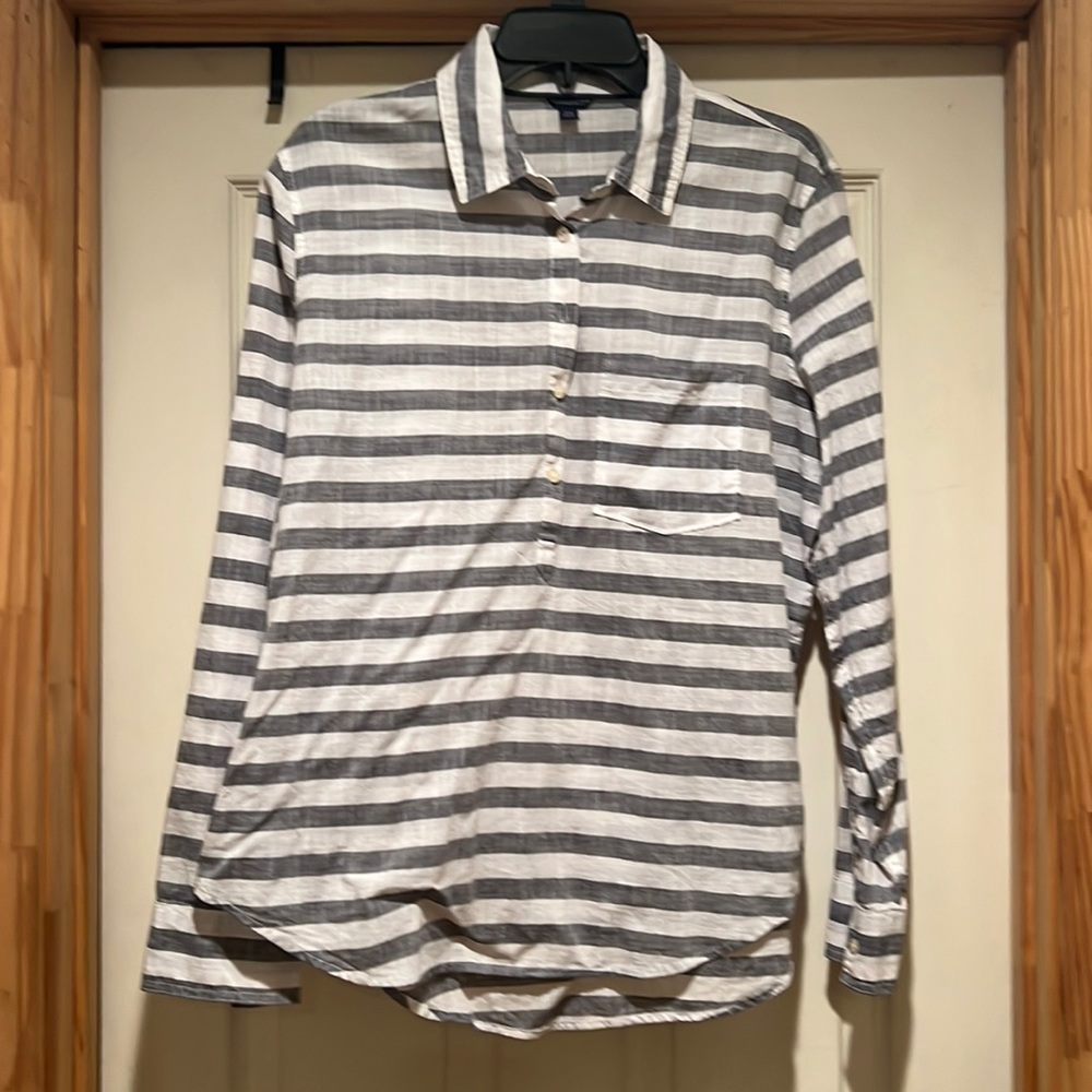 Nice grey and white striped blouse with front pocket.